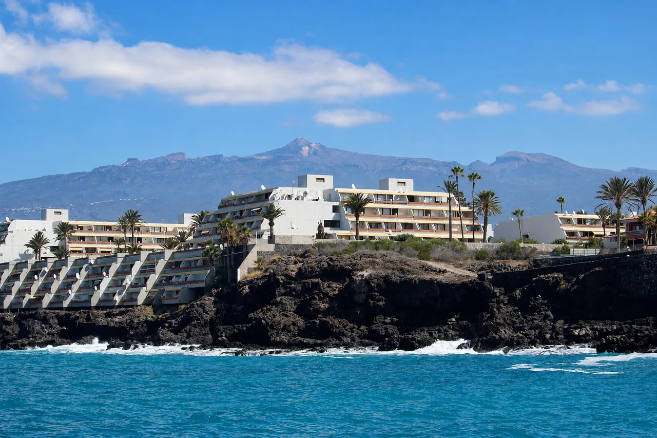 The coast at Amarilla Golf seen from the water, with Teide behind
