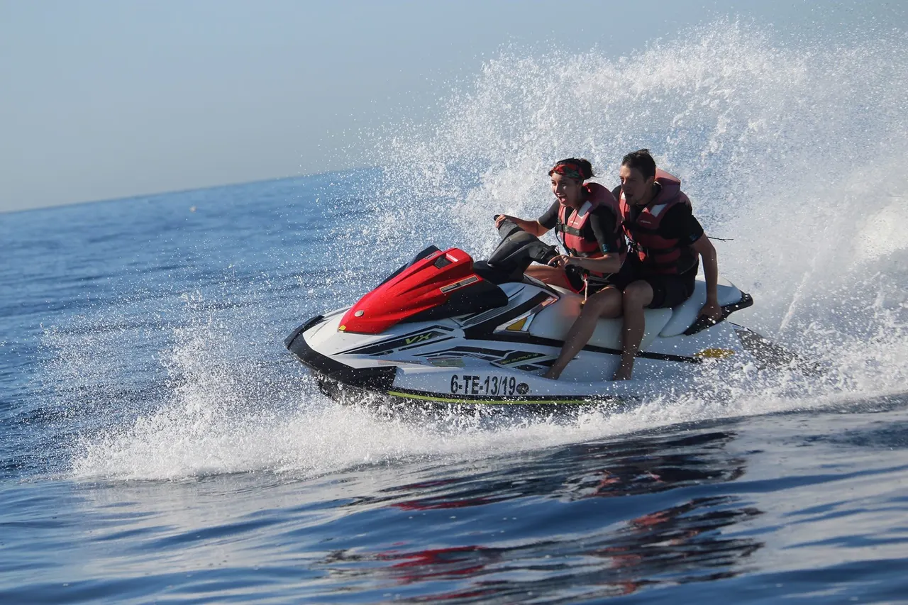 Two riders at speed close to the coast